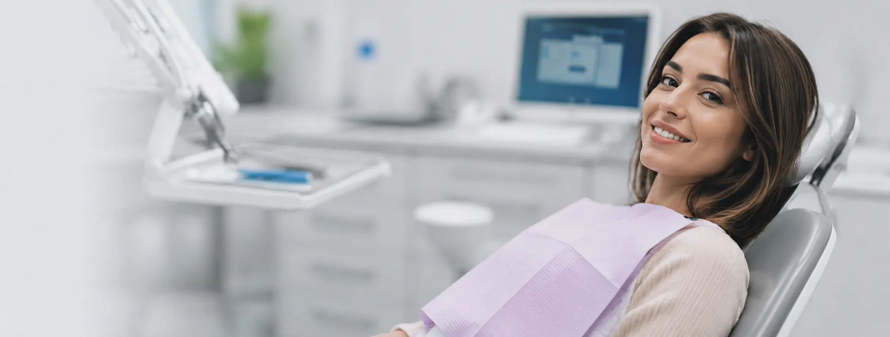 Smiling woman reclining in a dental chair